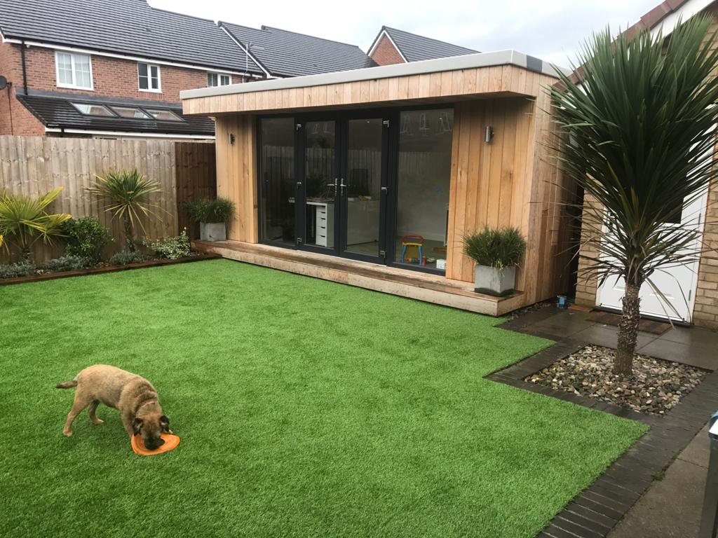 light wood clad garden room at the back of garden