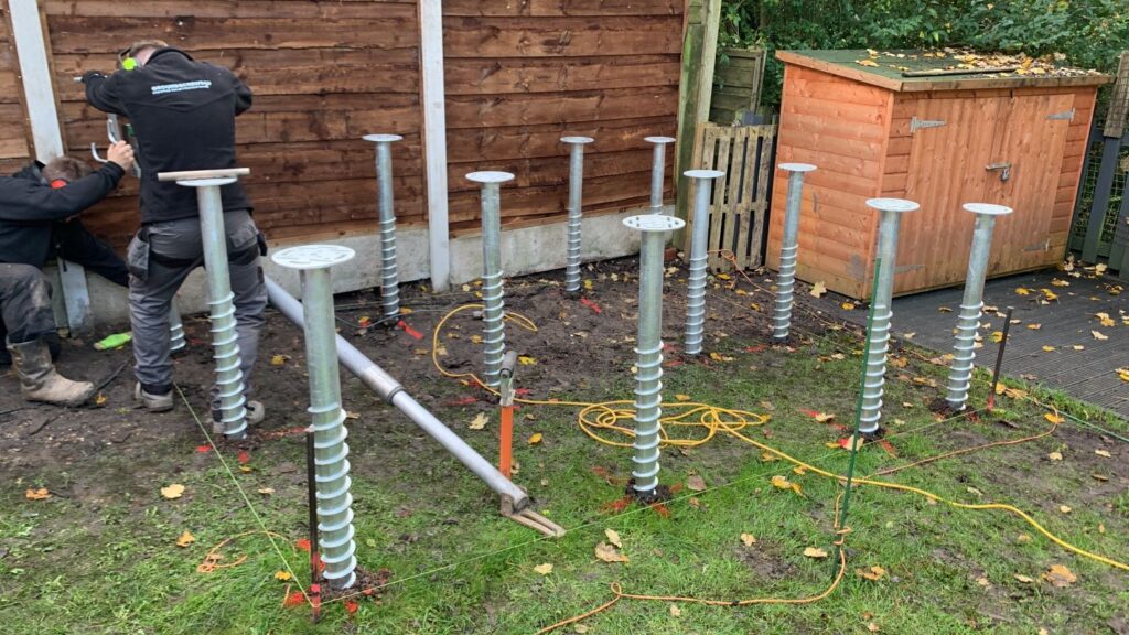 garden room ground screws being inserted with minimal disruption